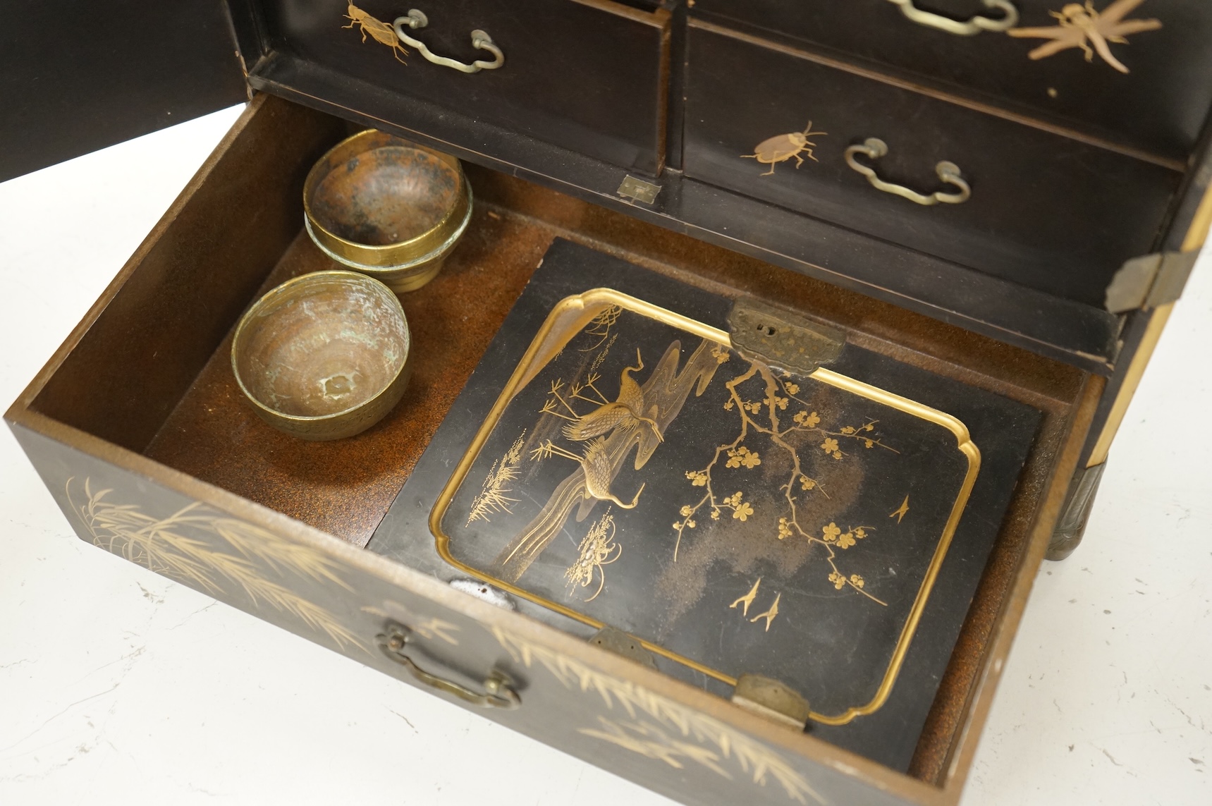 A Chinese export lacquered table cabinet with fitted interior, lacking door, 32cm high